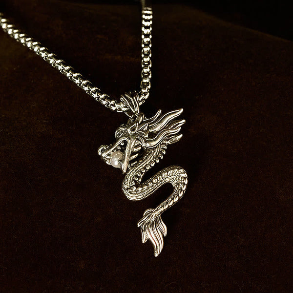 Copper Dragon Necklace – Pearl-clutching dragon on dark backdrop, spotlight, powerful