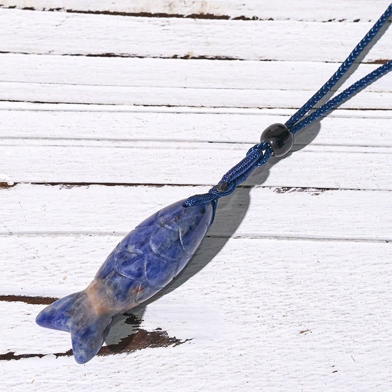 Koi Fish Crystal Necklace Pendant – amethyst pendant diagonal on rustic wood showing purple, gemstone jewelry