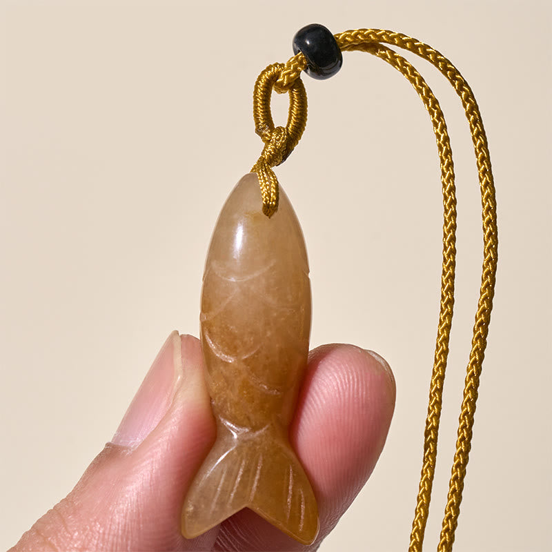 Koi Fish Crystal Necklace Pendant – pink crystal pendant held showing soft pink translucency, healing stone