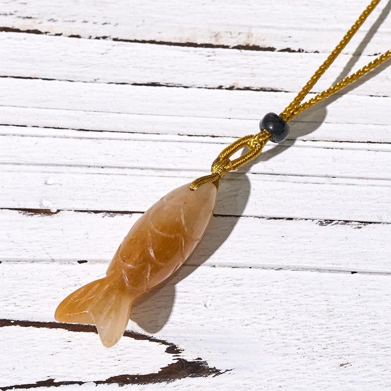 Koi Fish Crystal Necklace Pendant – pink crystal koi on white showing carved scales, rose quartz fish pendant