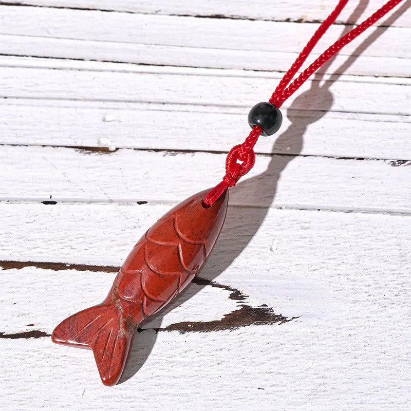 Koi Fish Crystal Necklace Pendant – amethyst pendant on white with purple cord detail, crystal fish necklace