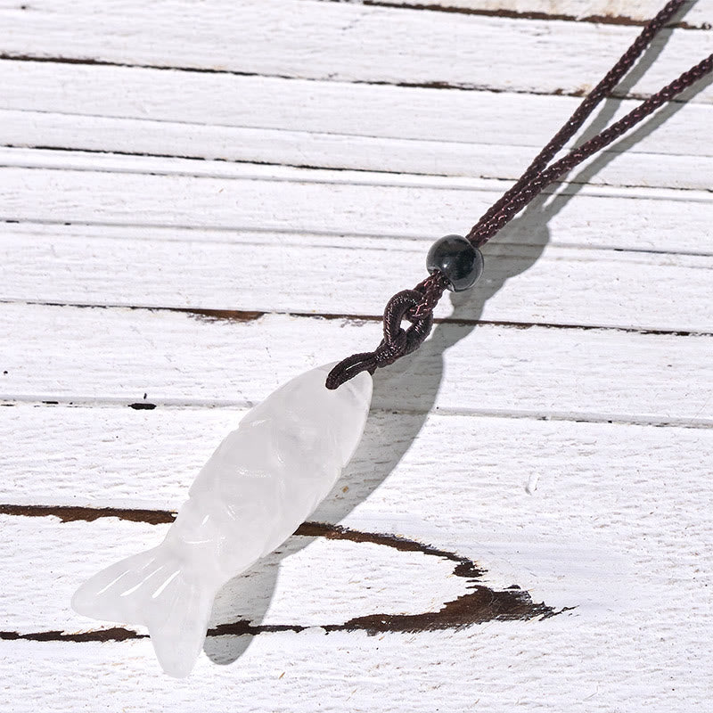 Koi Fish Crystal Necklace Pendant – white clear translucent koi pendant on weathered wood, clear quartz fish