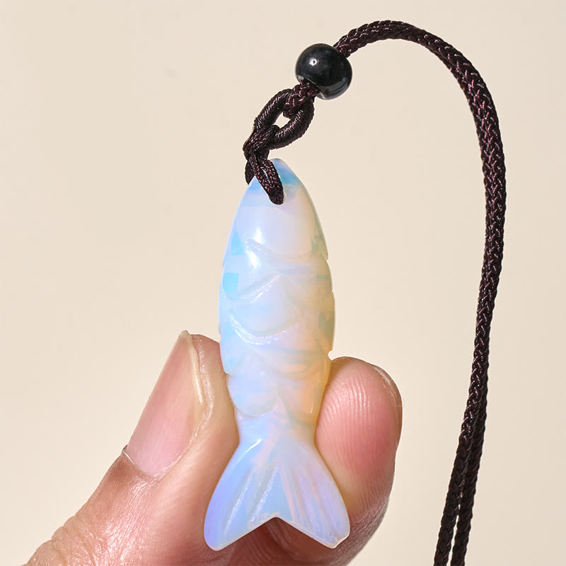 Koi Fish Crystal Necklace Pendant – green aventurine koi pendant held showing polished surface, healing stone