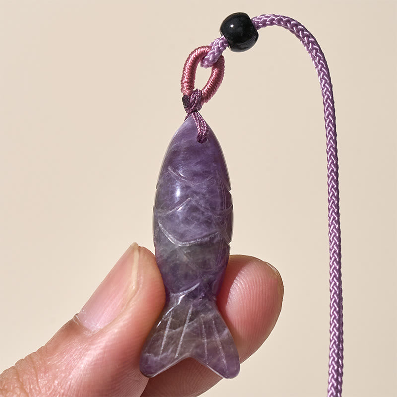 Koi Fish Crystal Necklace Pendant – amethyst koi pendant held in hand showing crystal banding, gemstone