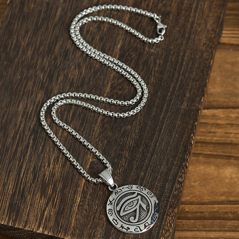Titanium Steel Necklace – Eye of Horus on box chain with lobster clasp on dark wood, flat lay S-curve