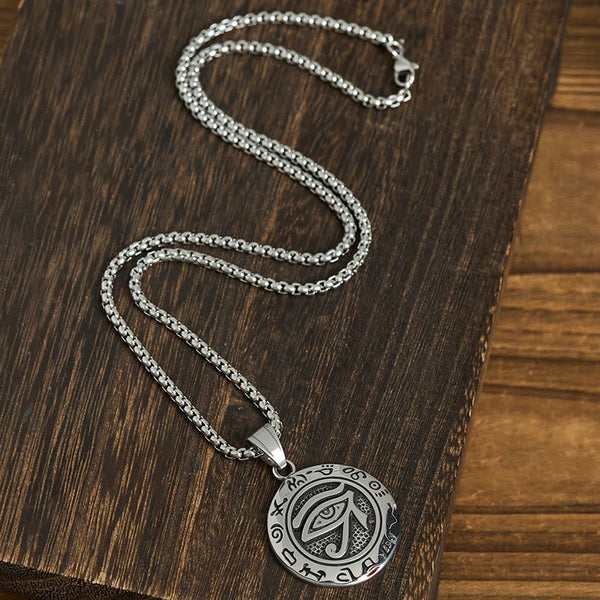 Titanium Steel Necklace – Eye of Horus on box chain with lobster clasp on dark wood, flat lay S-curve