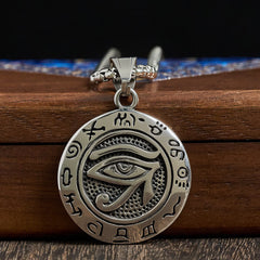 Titanium Steel Necklace – Silver Egyptian eye pendant with snake chain on brown wood, studio lighting