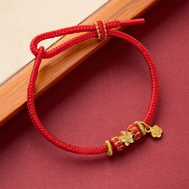 Fu Character Copper Bracelet – red string with wrapped barrel beads and four-petal gold charm, angled view, adjustable knot bracelet