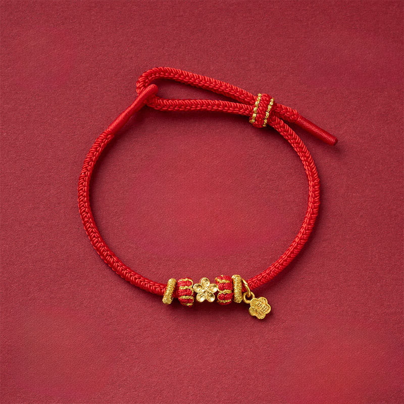 Fu Character Mantra Bracelet – red cord with gold flower charm and engraved pendant, beaded design, overhead view, fortune bracelet