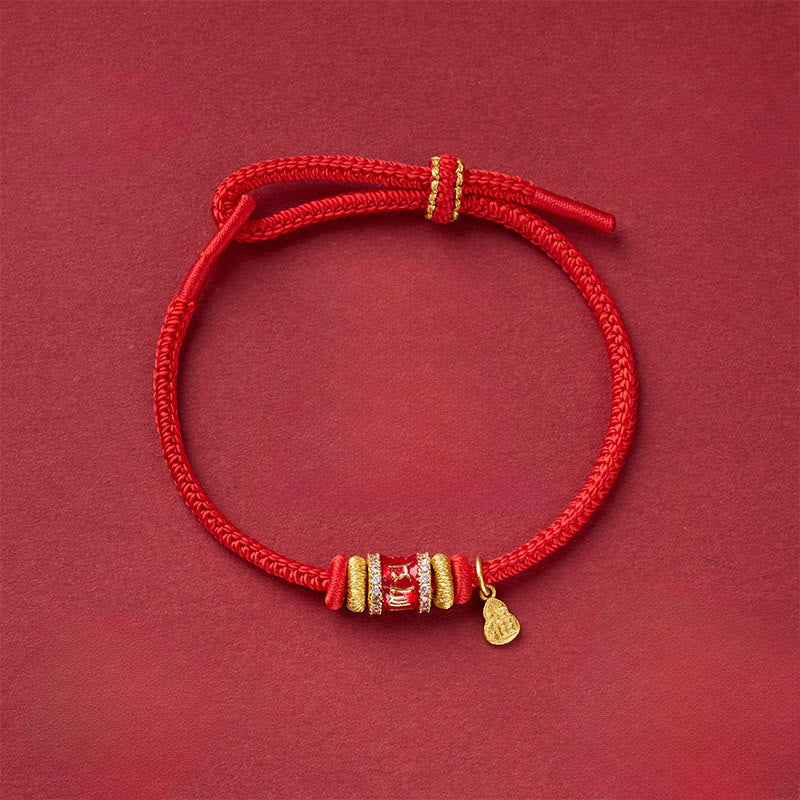 Fu Character Red String Bracelet – adjustable cord bracelet with crystal-embellished gold bead and teardrop charm, overhead view, red string bracelet
