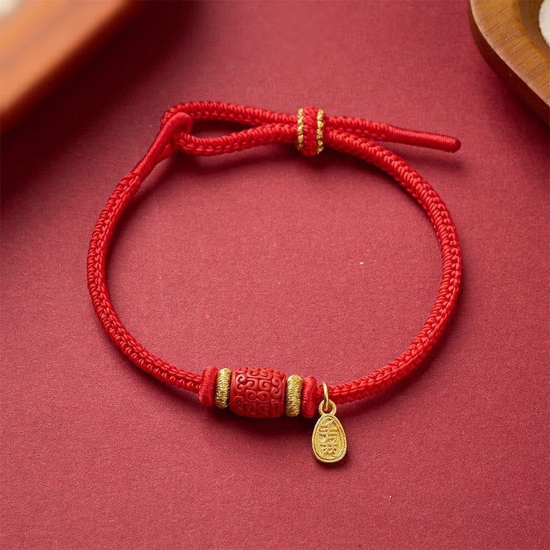 Fu Character Mantra Bracelet – red string with gold spacers and engraved charm, sliding knot closure, top-down view, blessing bracelet