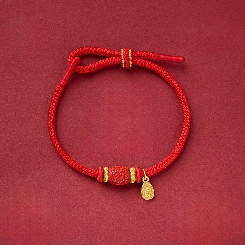 Fu Character Copper Bracelet – red cord bracelet with carved barrel bead and gold teardrop charm, overhead view, Chinese lucky bracelet