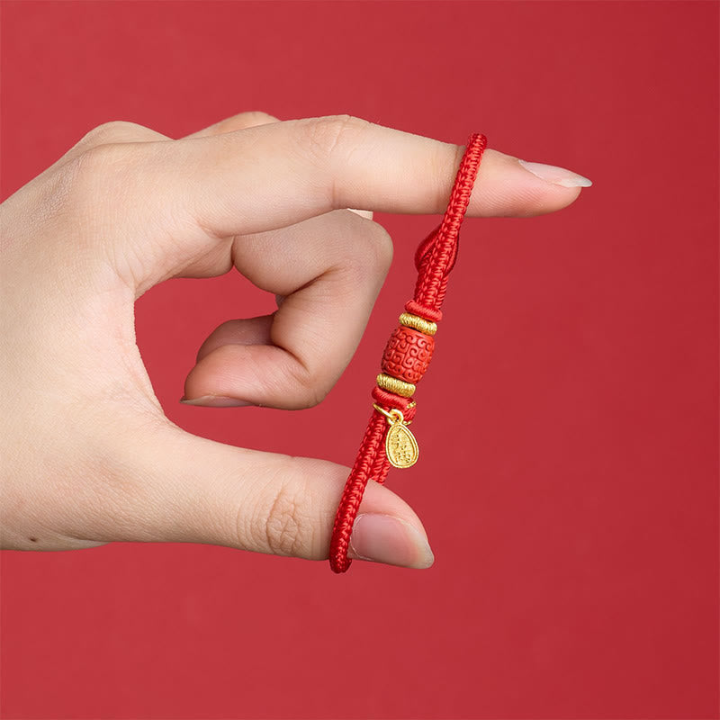 Fu Character Red String Bracelet – held by hand showing carved red bead and gold charm detail, side view, traditional Chinese bracelet