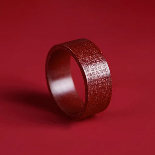 Cinnabar Heart Sutra Om Mani Padme Hum Blessing Ring – three-quarter side view showing sutra engraving on red band, engraved ring