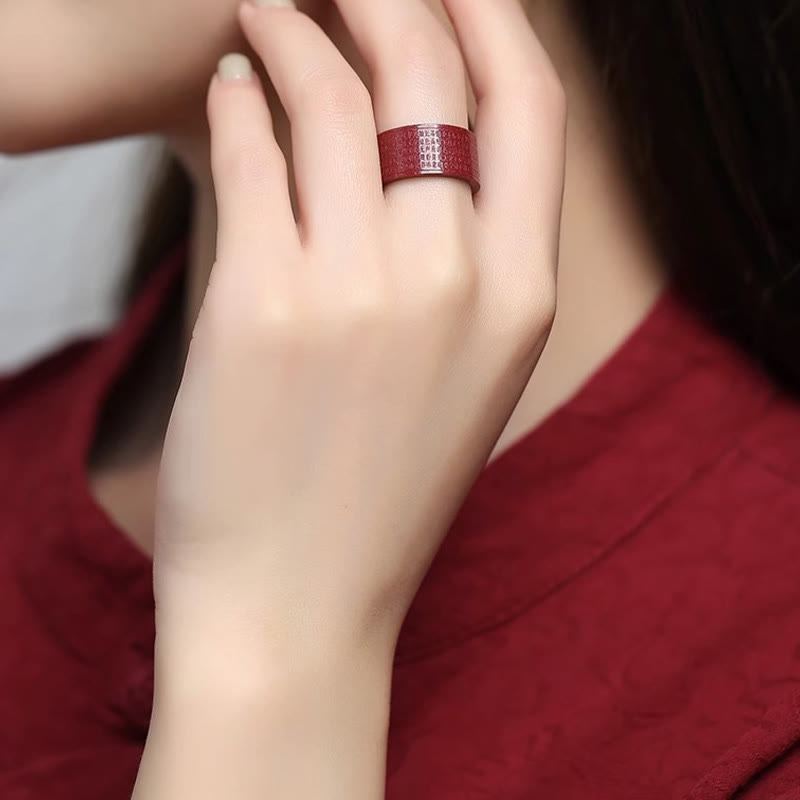 Cinnabar Heart Sutra Om Mani Padme Hum Blessing Ring – worn on finger with coordinating burgundy outfit, cinnabar band ring