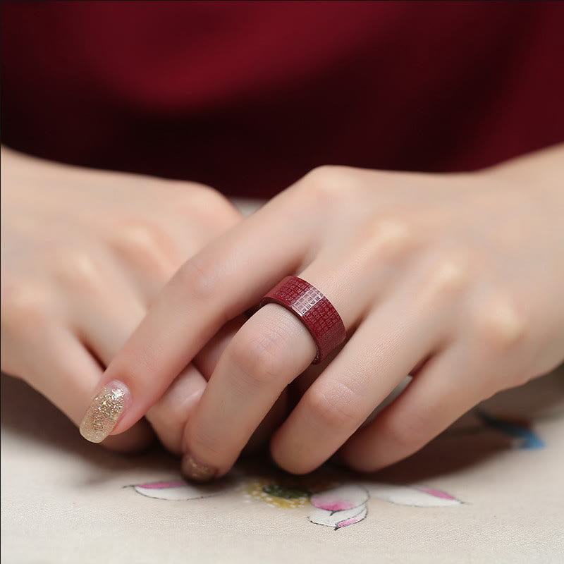 Cinnabar Heart Sutra Om Mani Padme Hum Blessing Ring – close-up on hand showing engraved mantra on red band, blessing ring