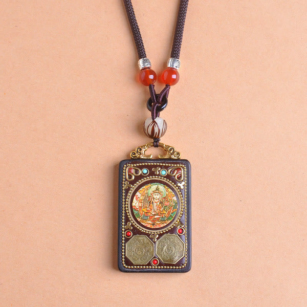 Zakiram Yin Yang Ebony Wood Pendant – front view on peach, Green Tara bodhisattva