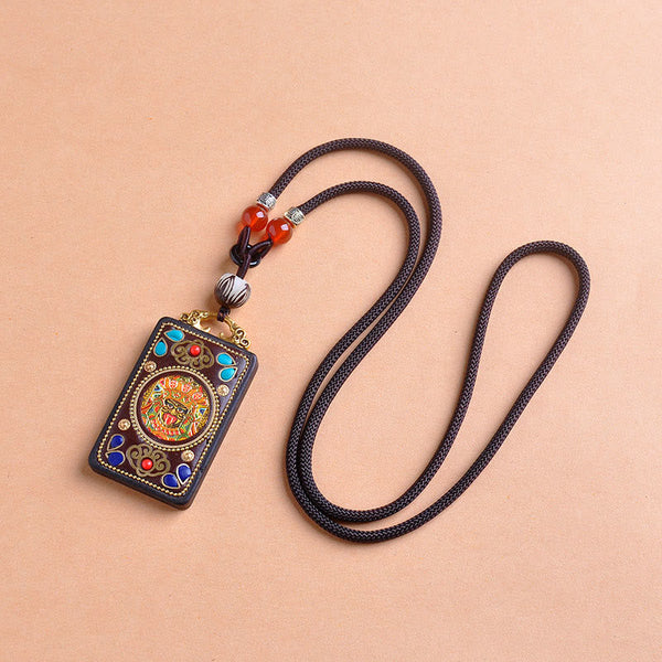 Zakiram Yin Yang Ebony Wood Pendant – flat lay on beige, turquoise inlay amulet