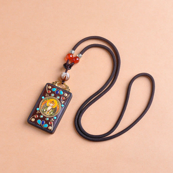 Zakiram Yin Yang Ebony Wood Pendant – flat lay diagonal, carnelian bead necklace