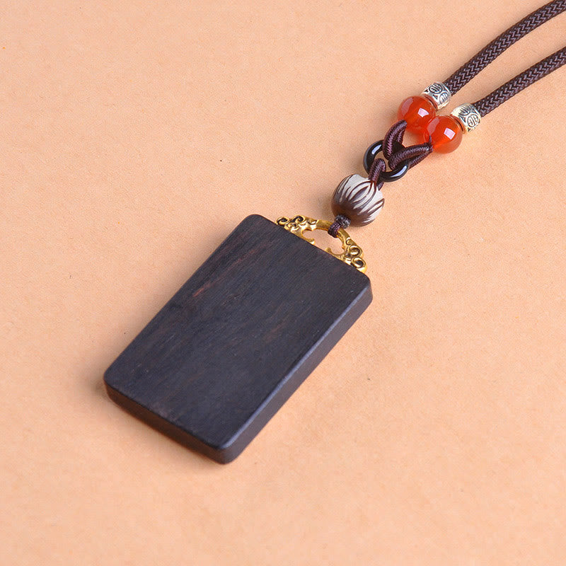 Zakiram Yin Yang Ebony Wood Pendant – 45-degree view, braided cord wood amulet