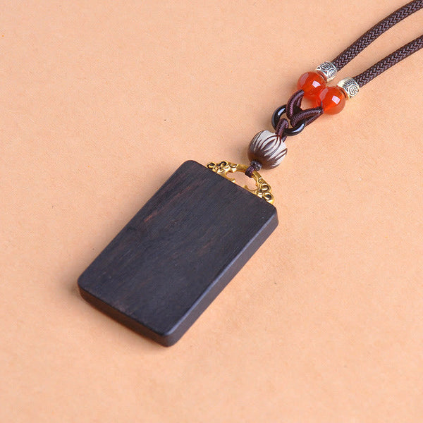 Zakiram Yin Yang Ebony Wood Pendant – 45-degree view, braided cord wood amulet