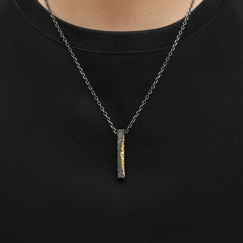 Om Mani Padme Hum Necklace – gold fissure bar pendant on model, black crew neck, sterling silver men's necklace