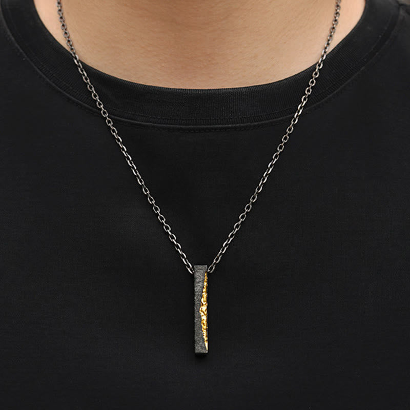 Om Mani Padme Hum Necklace – two-tone gold and black pendant worn on model, dark silver chain, men's spiritual jewelry