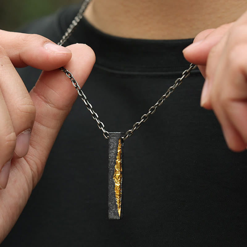 Om Mani Padme Hum Necklace – model holding pendant to show gold vein detail, dark oxidized finish, artisan silver necklace