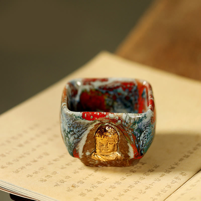 Hand-painted Dunhuang Meditating Buddha Shino Ceramic Teacup – hand holding cup at tea table, daily meditation ritual