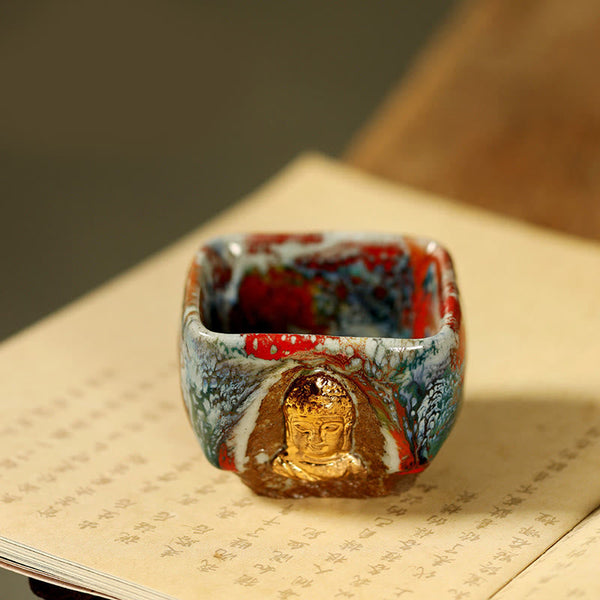 Hand-painted Dunhuang Meditating Buddha Shino Ceramic Teacup – hand holding cup at tea table, daily meditation ritual