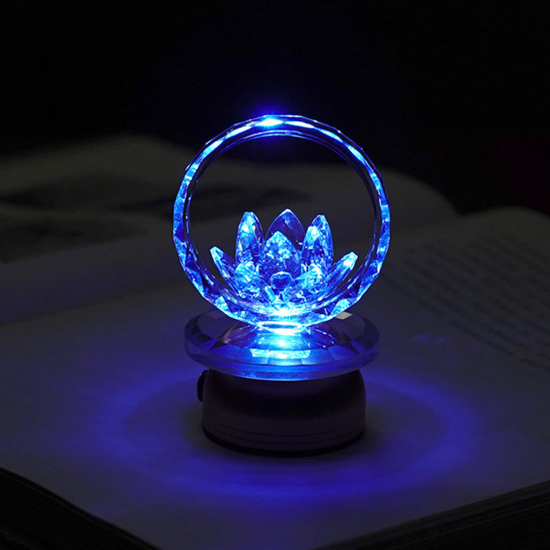 Blue LED crystal lotus ring lamp on book pages, color-changing lotus light