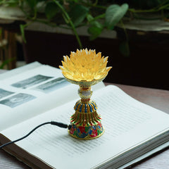 Lotus Liuli Glass Decor - golden crystal lotus flower lamp with faceted amber petals and multicolor enamel base on open book, spiritual home decor