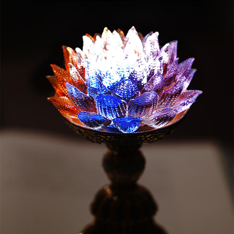 Lotus Liuli Glass Decor - illuminated amber lotus lamp with gold cloisonne enamel base on open book, warm LED glow