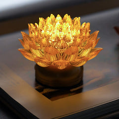 Lotus Liuli Lamp – warm amber glow on dark wood surface, liuli glass