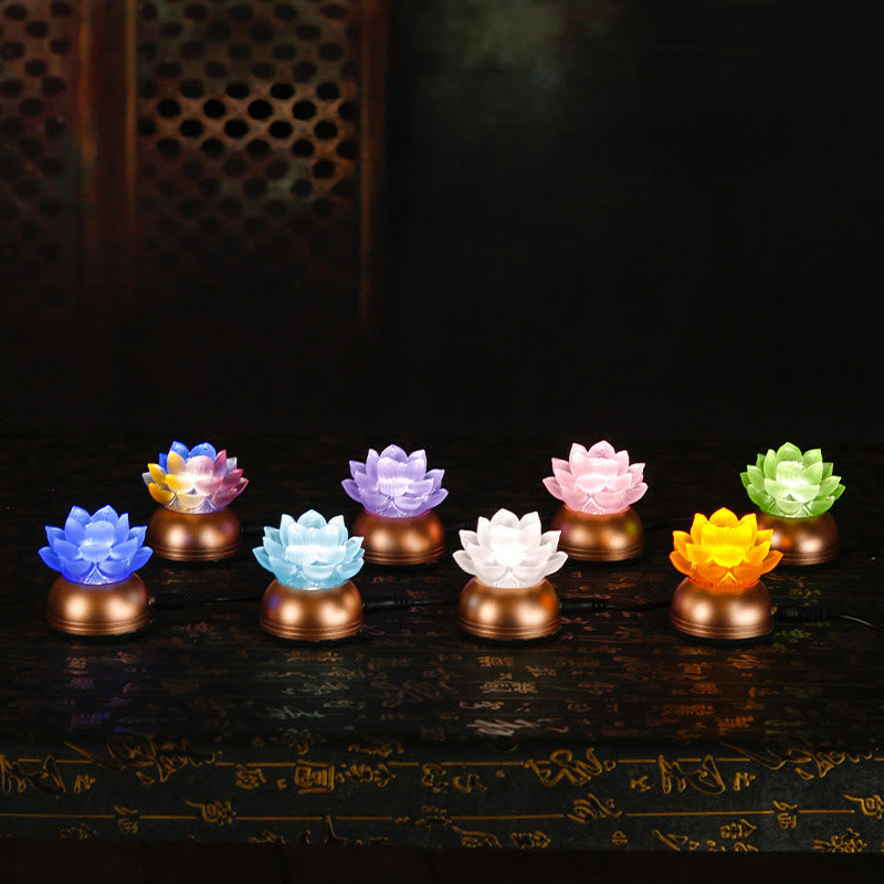 Eight color variants of lotus LED lamps on dark altar surface, liuli light set