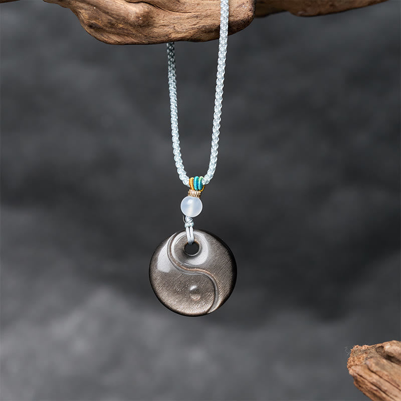Silver Sheen Obsidian Yin Yang Pendant – hanging on driftwood, obsidian meditation jewelry