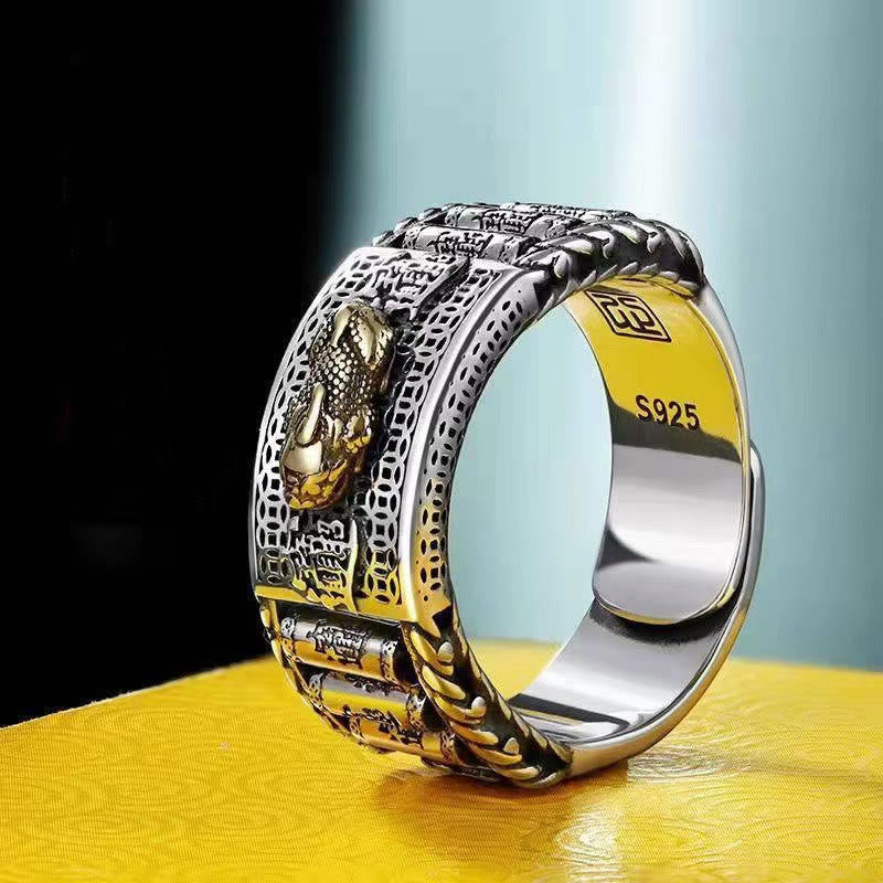 Feng Shui PiXiu Wealth Prayer Wheels Couple Ring – side view of silver band with gold PiXiu and prayer wheels on yellow fabric, S925 sterling