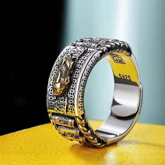 Feng Shui PiXiu Wealth Prayer Wheels Couple Ring – side view of silver band with gold PiXiu and prayer wheels on yellow fabric, S925 sterling