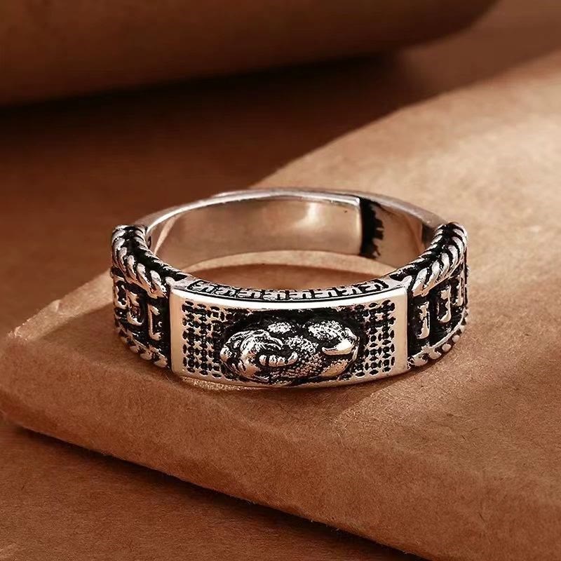 Feng Shui PiXiu Wealth Prayer Wheels Couple Ring – flat lay on brown paper highlighting prayer wheel columns and textured pattern, S925 silver