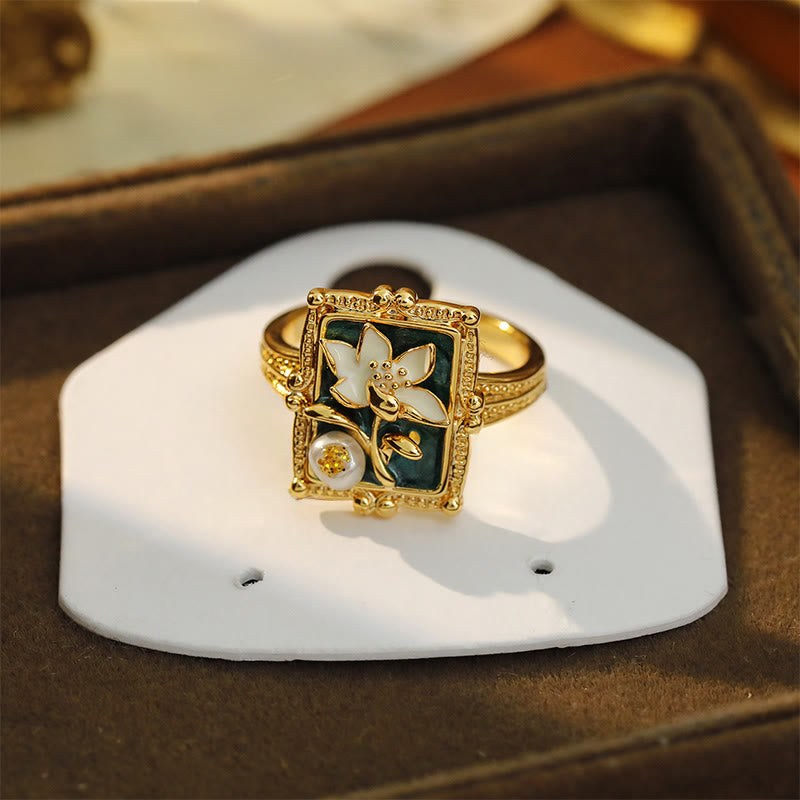 Vintage Lotus Pearl Copper Ring – mother-of-pearl lotus on green enamel with gold accent stone, display stand