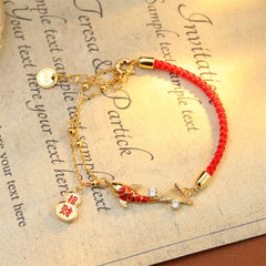Koi Fish Wealth Gourd Red String Bracelet – flat lay on white background displaying gourd and koi fish charms