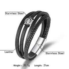 Braided Leather Bracelet – Flat and braided black leather with stainless steel eye bead, white backdrop