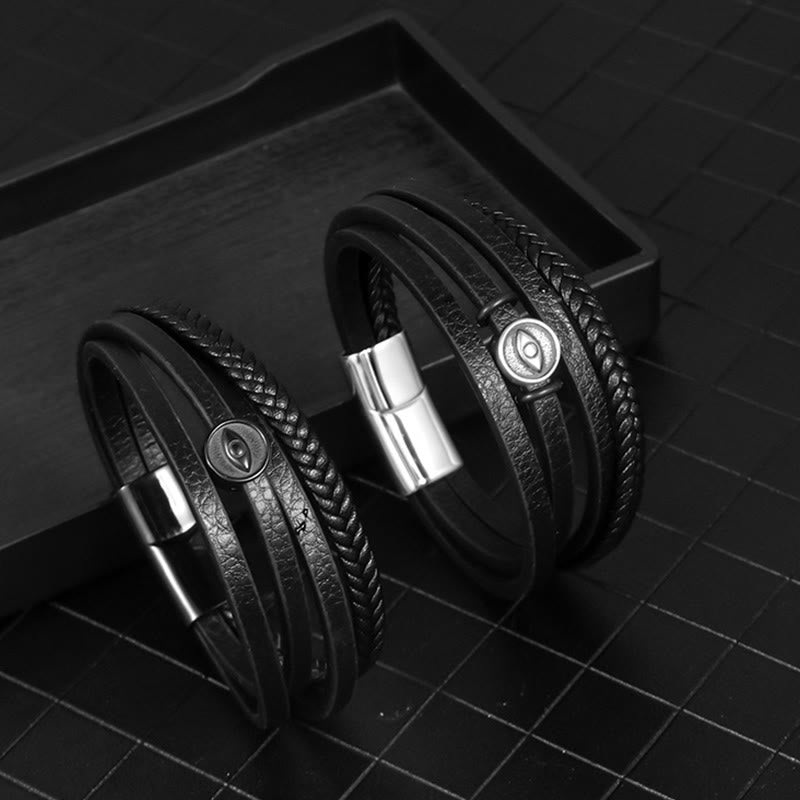 Leather Balance Bracelet – Two black leather bracelets on dark tray, evil eye medallion detail