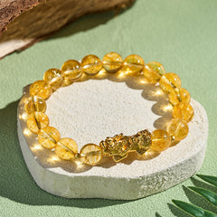 Natural Citrine Pixiu Prosperity Protection Bracelet - 10mm – Bracelet on white stone green background, 10mm beads