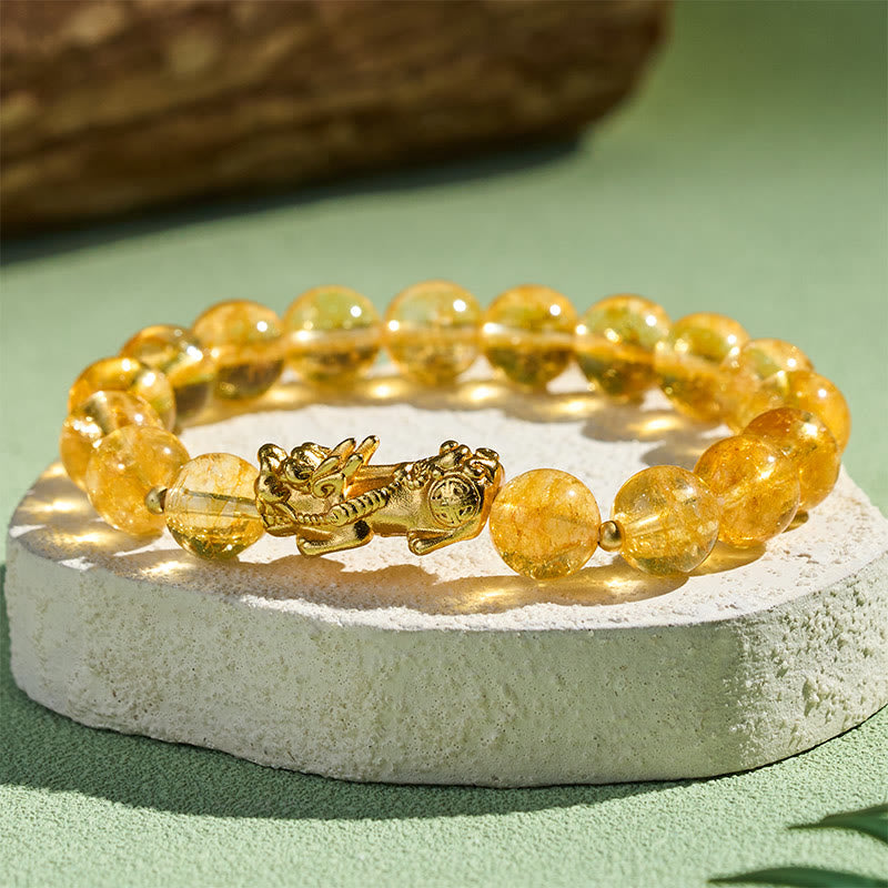 Natural Citrine Pixiu Prosperity Protection Bracelet - 10mm – Side close-up on white stone green bg, golden shine