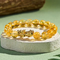 Natural Citrine Pixiu Prosperity Protection Bracelet - 10mm – Side close-up on white stone green bg, golden shine