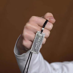 Namo Amitabha Copper Rope Necklace - Hand-held pendant showing engraved talisman text, spiritual jewelry