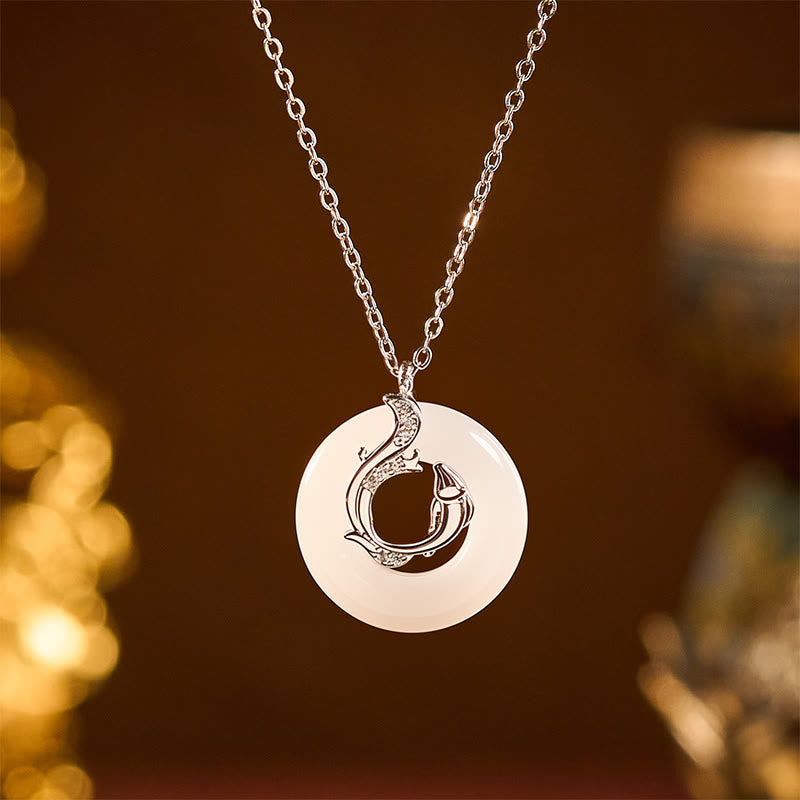 Koi Fish Peace Buckle Necklace – frontal macro, jade disc with silver dragon overlay, pave stones, brown bokeh
