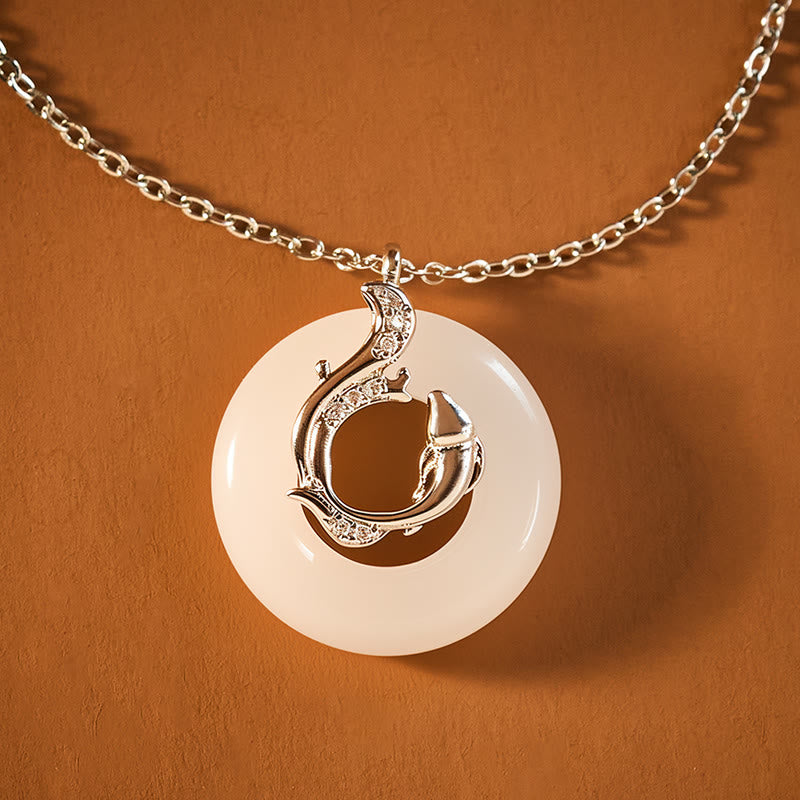 Koi Fish Peace Buckle Necklace – jade disc with silver double fish yin-yang overlay, crystals, sienna background