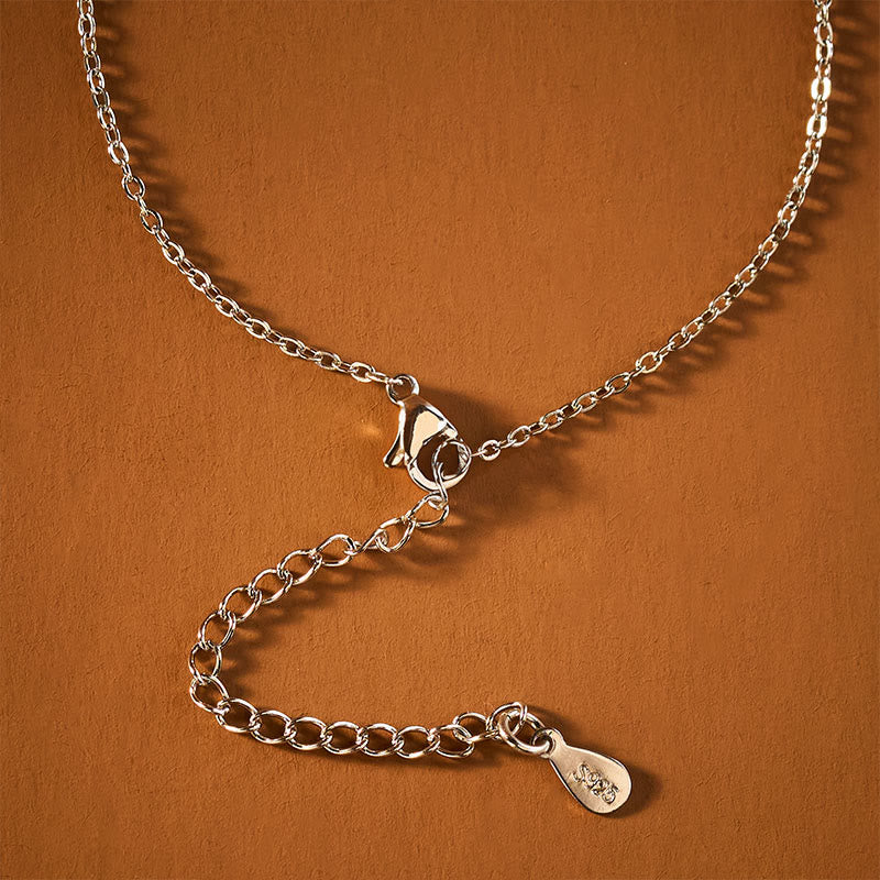 Koi Fish Peace Buckle Necklace – macro chain clasp and extender detail, 925 stamp, on terracotta surface